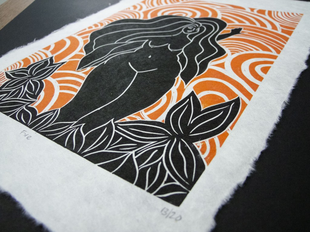 A linocut print of a female figure representing fire, surrounded by swirling orange patterns and black foliage.