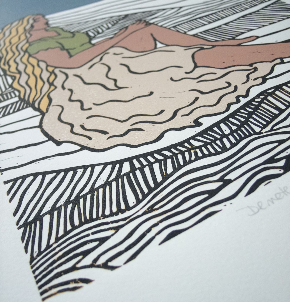 linocut print of demeter sitting behind a black and white world
