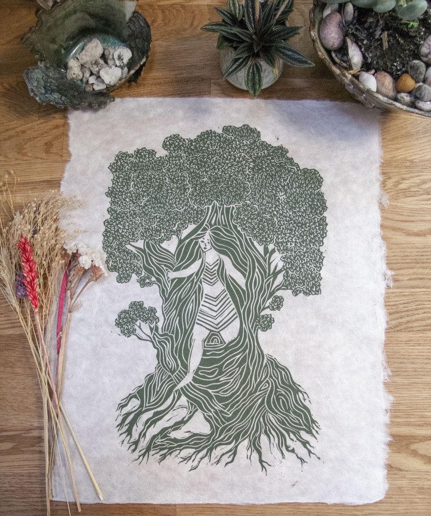 A hand-printed linocut illustration of a Dryad emerging from a tree, surrounded by natural elements such as dried flowers and potted plants, depicting the connection between the nymphs and nature.
