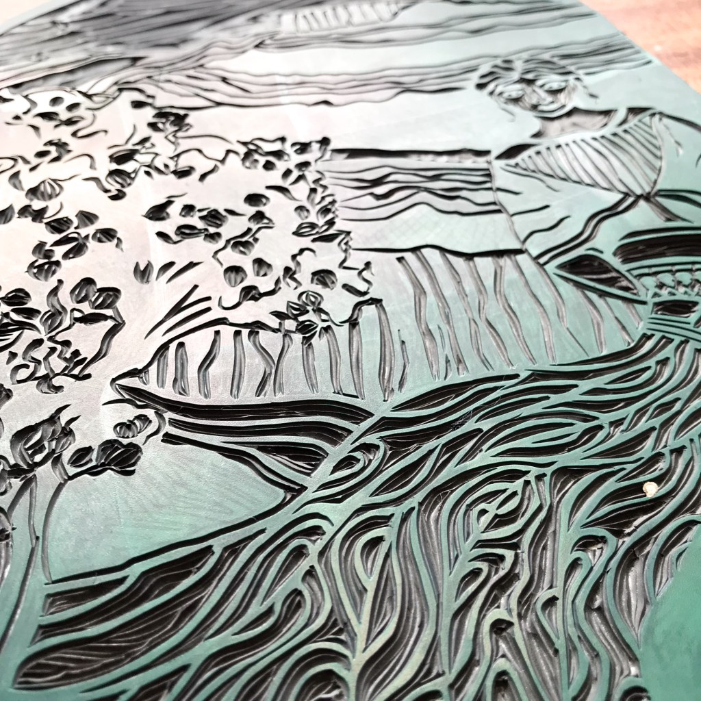 Close-up of a linocut carving depicting artistic elements inspired by Goddess Anahit of Armenia, featuring intricate designs of flowing lines and floral motifs.