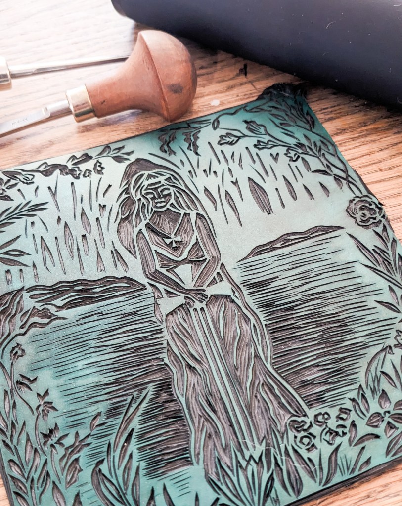 lady of the lake square linocut print of a woman in a lake holding a sword. black and white