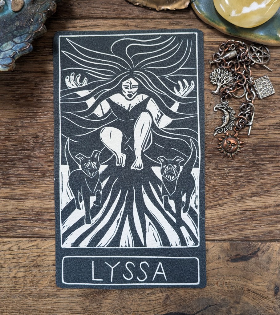 oracle card of goddess lyssa with text black and white linocut art. feminine rage