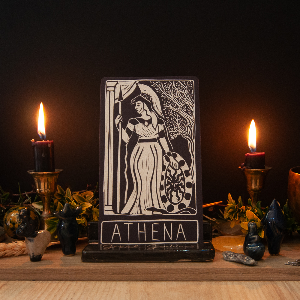 linocut card of athena on a goddess altar with black candles, moody atomsphere